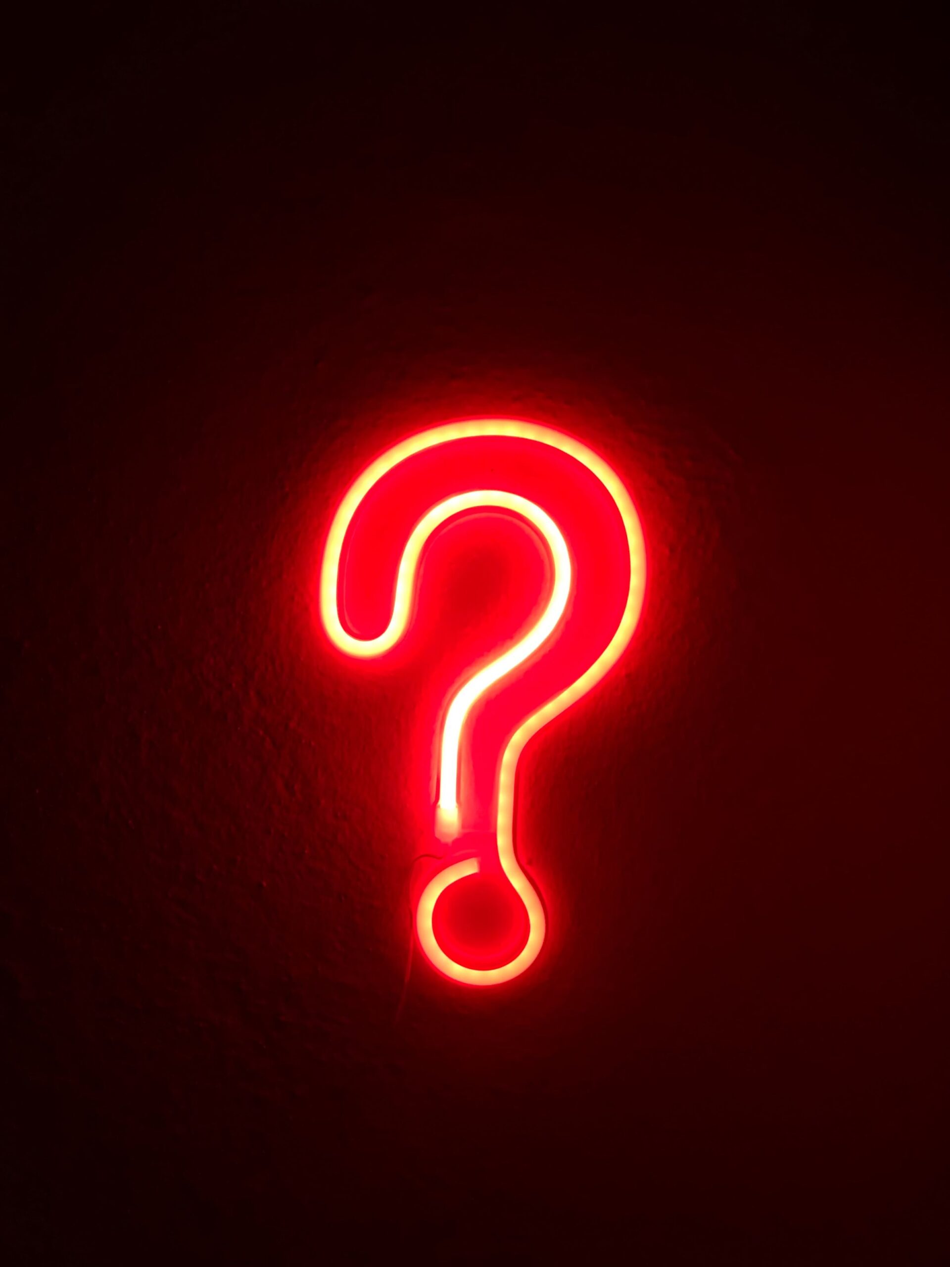 A red question mark on a black background, suitable for DJs in Alberta and Edmonton.