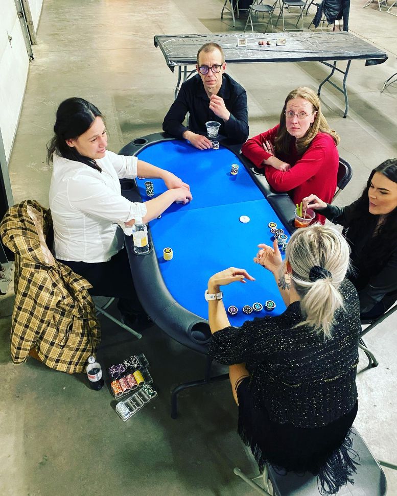 A group of people sitting around a poker table in Edmonton, Alberta.